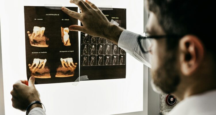 person in gray long sleeve shirt holding black tablet computer